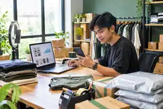 Seorang seller mengelola toko online melalui ponsel dan laptop, dengan produk fashion, rak barang, dan paket pesanan di ruang kerja e-commerce.